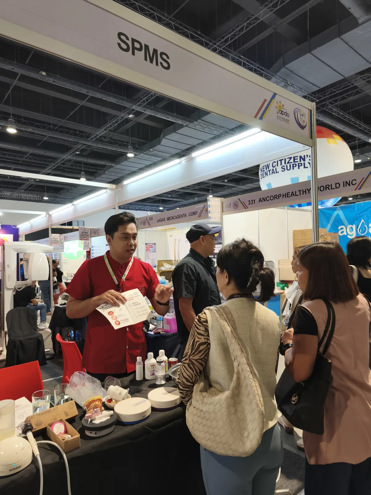 SPMS team speaking with visitors at a dental trade exhibit