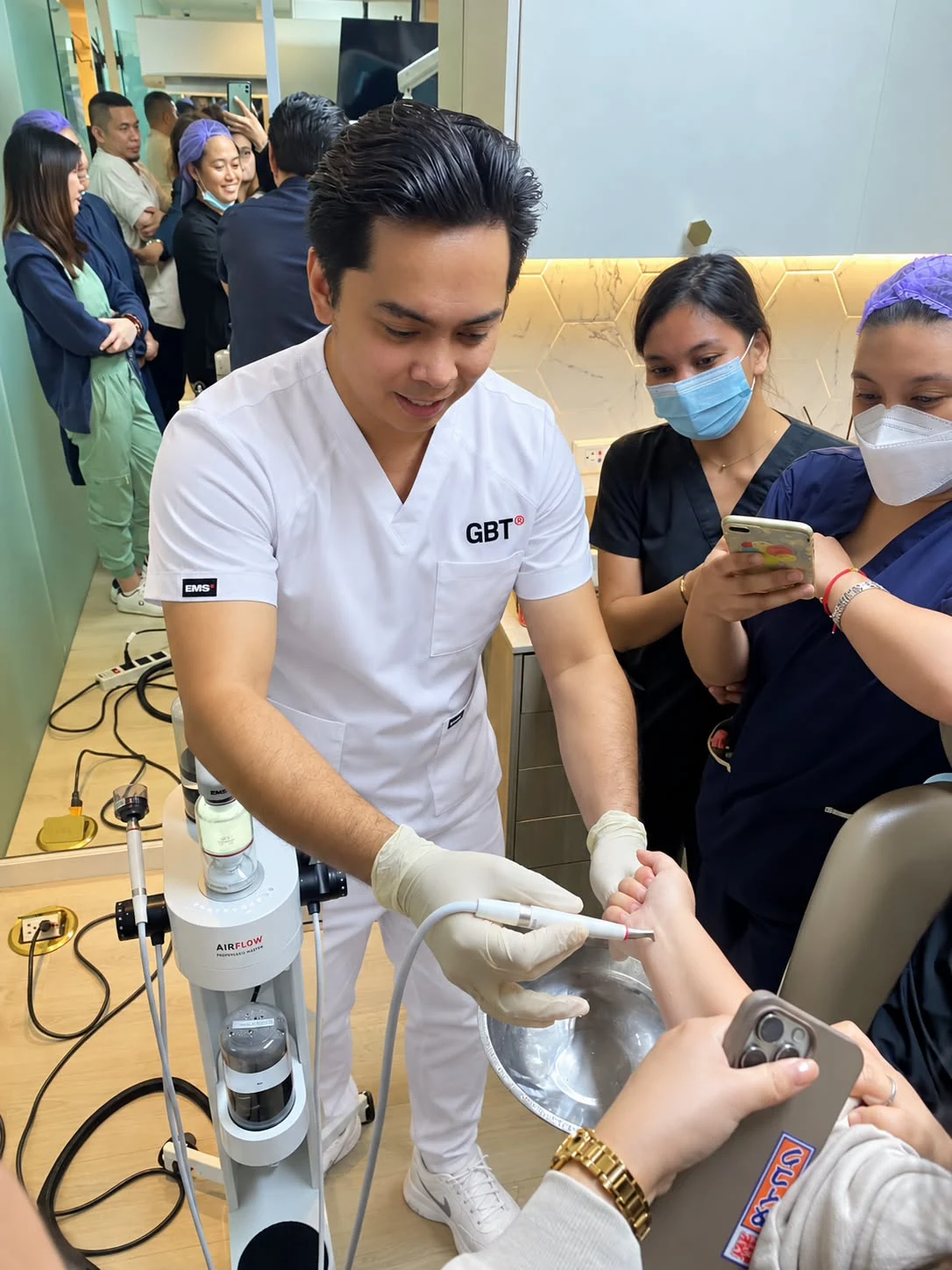 SPMS representative providing hands-on AIRFLOW equipment guidance to a dental team