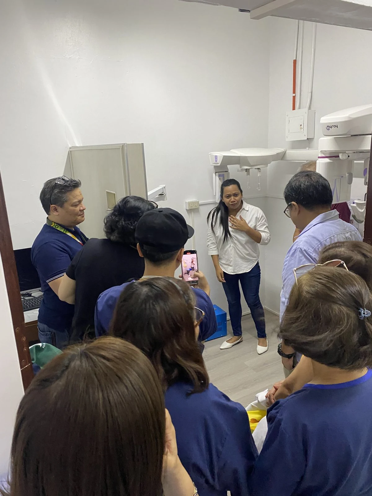 Dental professionals attending an equipment orientation beside MyRay imaging systems